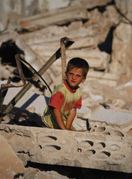A child amid the rubble of Taflanaz in June, 2012